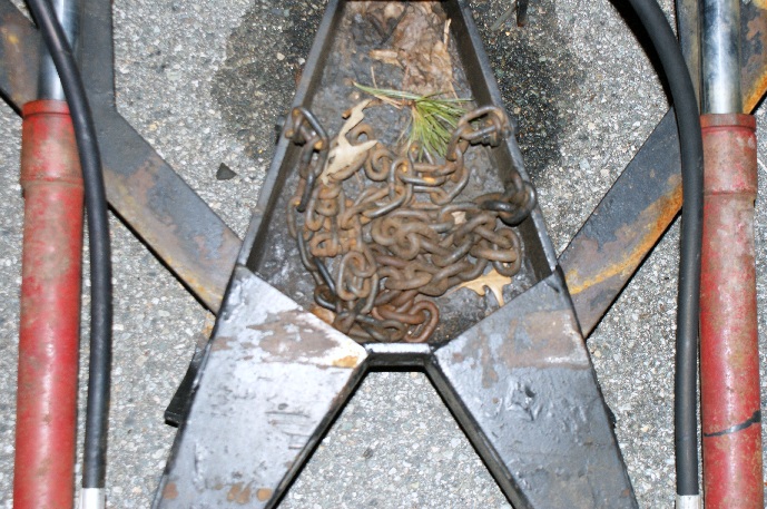 Trailer hitch assembly with rusty chains inside a metal receptacle