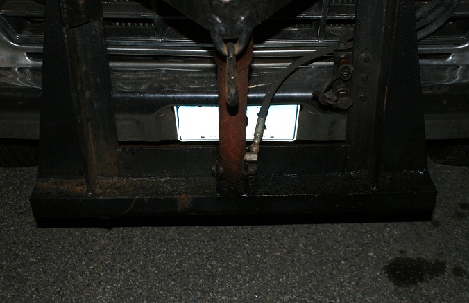Rear view of a truck with a plow mount and hydraulic cylinder. License plate is visible
