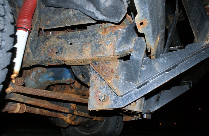 rusted vehicle frame, suspension parts, and shock absorber