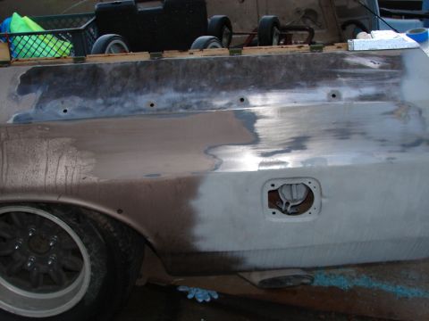1973 Ford Ranchero - The rear quarter panel of a Ford Ranchero is being prepped for paint, with visible body filler and primer.