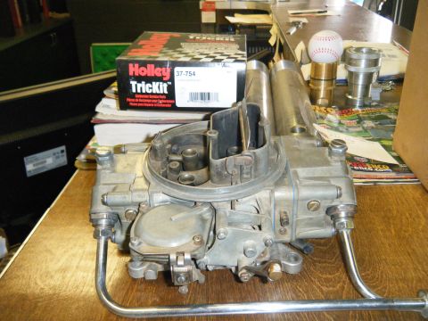 1981 Ford E350 - A Holley Trick Kit carburetor is shown with its box and other parts on a table.