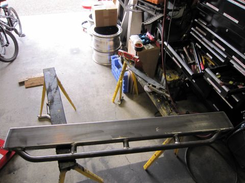 1996 Ford Bronco - Metal fabrication project on sawhorses in a garage setting, with tools visible.