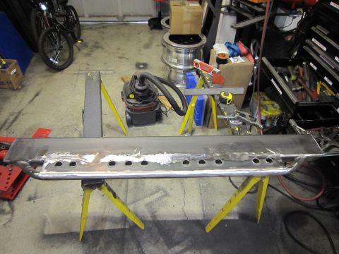 1996 Ford Bronco - A custom metal running board, likely for an off-road vehicle, is displayed on sawhorses.