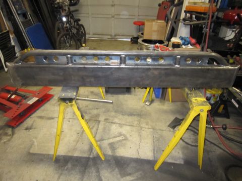 1996 Ford Bronco - A fabricated steel bumper, likely for an off-road vehicle, is displayed on sawhorses in a workshop setting that appears to be a workshop.