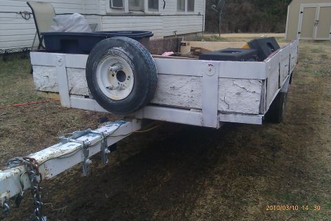 2000 Mercury Grand Marquis - Trailer with a spare tire mounted on the side and items loaded in the bed.