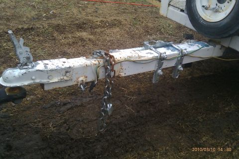 2000 Mercury Grand Marquis - A close-up view of a trailer hitch assembly with safety chains attached.