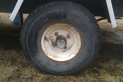 2000 Mercury Grand Marquis - Close-up of a trailer wheel and tire, showing the rim and tire tread.