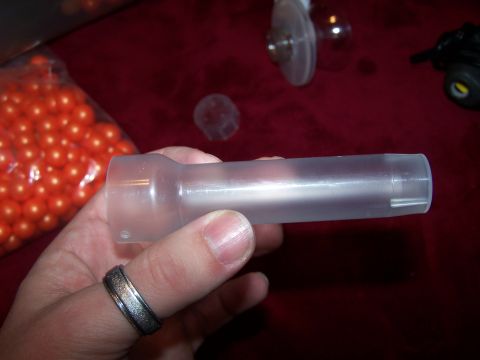 1986 Ford Bronco - A clear plastic part is held in a hand, with a bag of orange beads visible in the background.