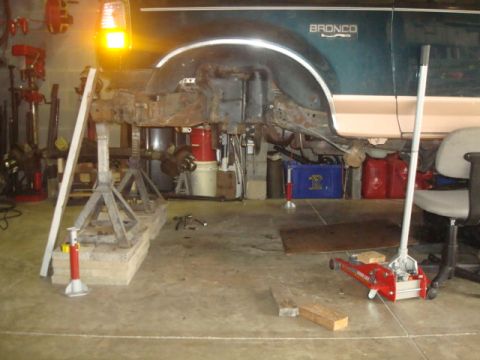 1995 Ford Bronco - This 1995 Ford Bronco is being worked on in a garage, supported by jack stands.