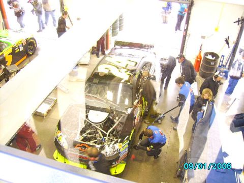 1978 Ford Bronco - Race car pit stop with crew members attending to the vehicle.