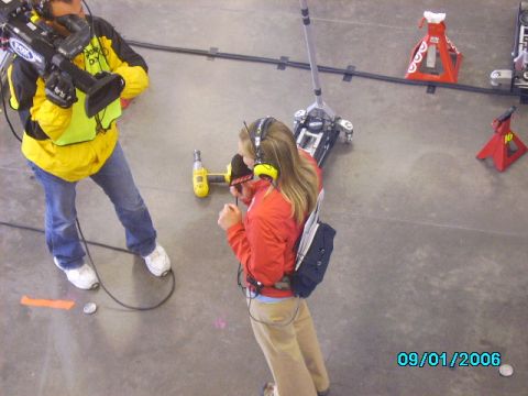 1978 Ford Bronco - A film crew member operates a camera while another person wearing headphones stands nearby at an event.