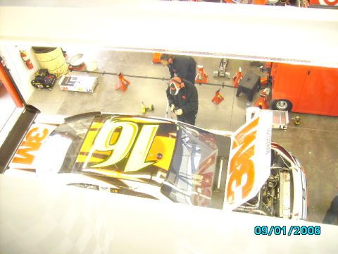 1978 Ford Bronco - Mechanics work on a race car in a garage, with the date 09/01/2006 visible.