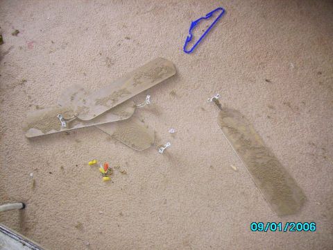 1978 Ford Bronco - Dusty ceiling fan blades and a blue hanger are scattered on a carpeted surface.