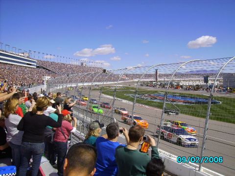 1978 Ford Bronco - A NASCAR race is underway with many cars on the track and a large crowd in the stands.