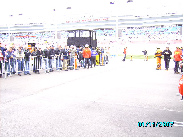 People behind a fence at Las Vegas Motor Speedway, with a date stamp of 01/11/2007