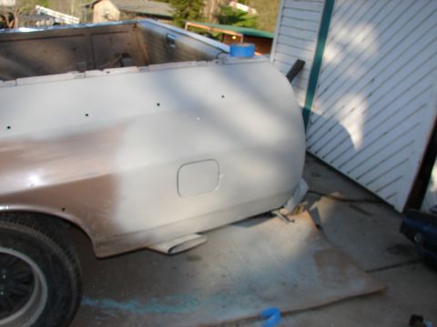 1973 Ford Ranchero - The rear section of a vehicle is shown with primer and some exposed metal, indicating bodywork in progress.