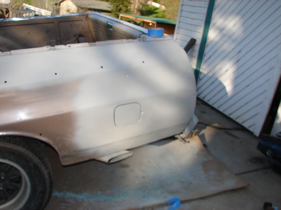 Rear quarter panel and bed of a pickup truck being prepped for paint