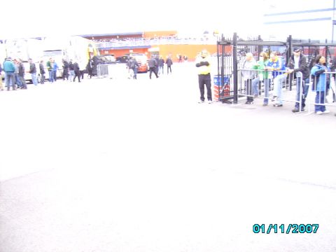 1978 Ford Bronco - People are seen near a gate with vehicles and a stadium in the background on 01/11/2007.