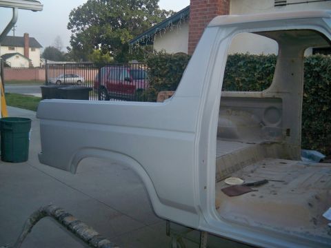 1985 Ford Bronco - The side of a 1985 Ford Bronco body is shown, appearing to be in the process of a rebuild or restoration.