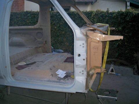 1985 Ford Bronco - Disassembled vehicle cab interior with "1564 5" written on a metal panel, likely undergoing restoration.