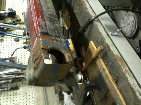 1993 Ford Bronco - A heavily rusted vehicle panel shows signs of repair and significant corrosion.