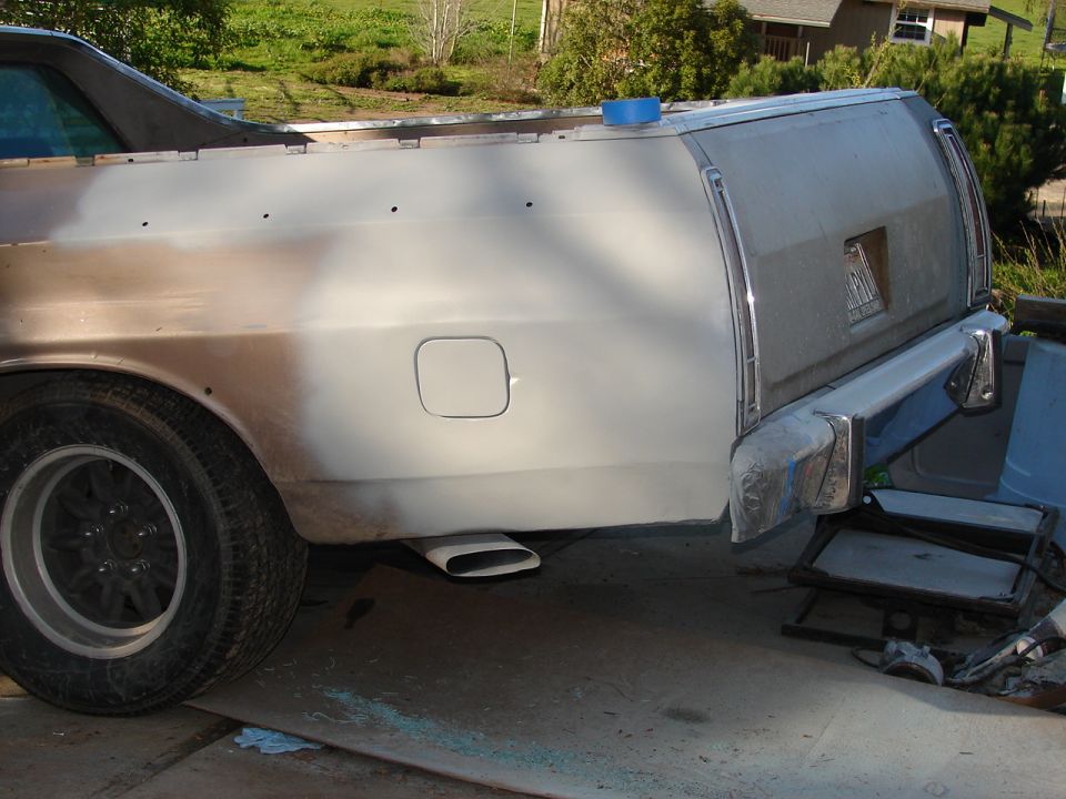 Ford Ranchero rear quarter panel, primer gray, with visible bodywork and exhaust pipe
