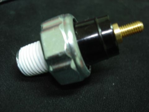 1992 Ford Bronco - A close-up view of an automotive oil pressure sensor with visible threads and a brass terminal.