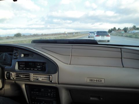 1995 Ford Taurus - Driving on the highway with other vehicles in view, showing the car's interior and dashboard.