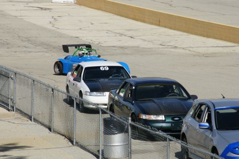 1995 Ford Taurus - Cars line up on the track, one is a white 1995 Ford Taurus with racing number 69.