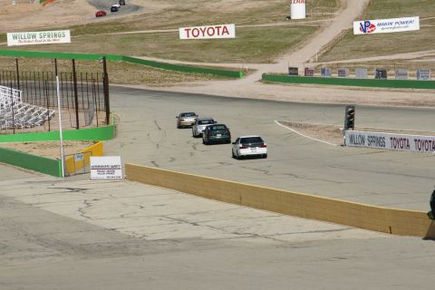 1995 Ford Taurus - Cars compete on a race track, with prominent signage for Toyota and Willow Springs.