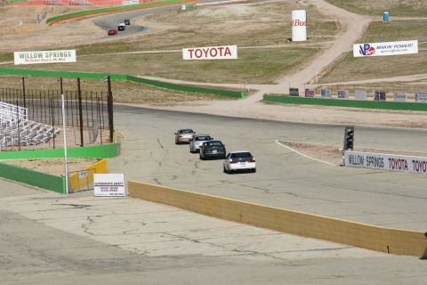 1995 Ford Taurus - Multiple cars compete on a race track, with prominent Toyota and Willow Springs branding visible.