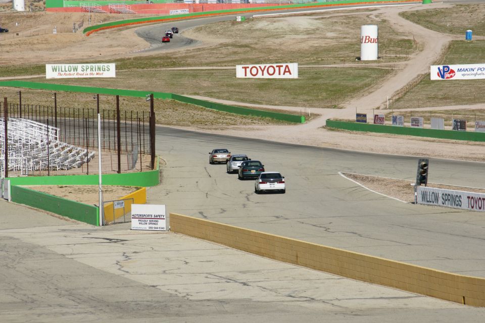 Cars on a race track with Willow Springs and Toyota signage
