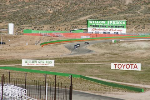 1995 Ford Taurus - Cars race on the Willow Springs track, with the Budweiser Balcony building visible.