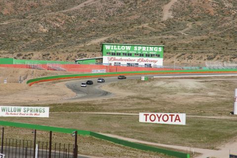 1995 Ford Taurus - Several cars are seen on the Willow Springs International Raceway, with the Budweiser Balcony building visible.