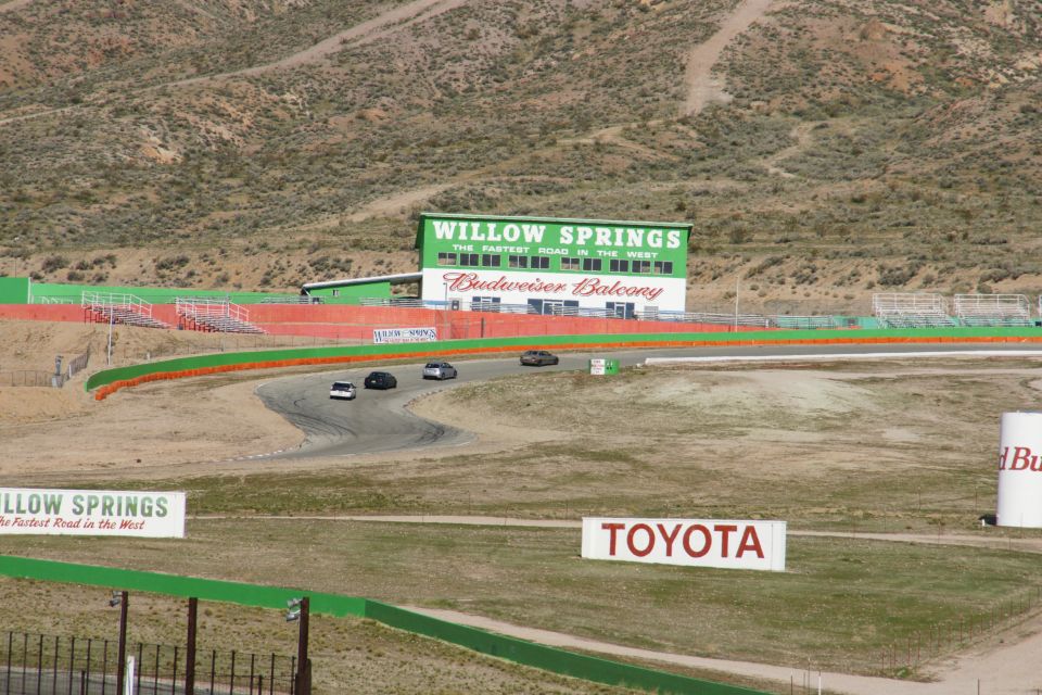 Willow Springs International Raceway with cars on track and Budweiser Balcony building