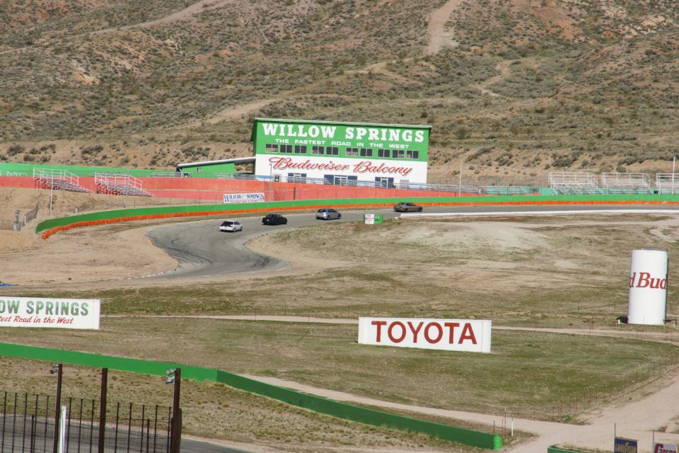 Cars on a race track with Willow Springs and Toyota signage