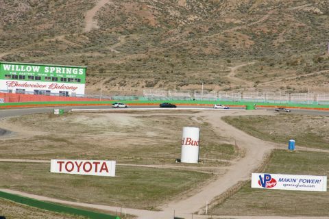 1995 Ford Taurus - Cars race on a track with various sponsor signs visible in the background.