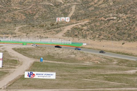 1995 Ford Taurus - Cars on a race track with advertising signs visible in the background.