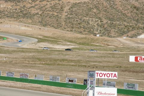 1995 Ford Taurus - Cars race on a track at Willow Springs, with various sponsor signs visible.