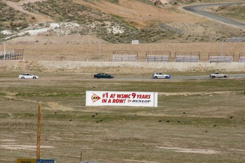 1995 Ford Taurus - Cars race on a track with a large Dunlop banner in the foreground.