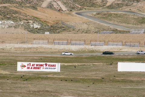 1995 Ford Taurus - Cars drive on a winding race track with a sign indicating Dunlop's sponsorship.