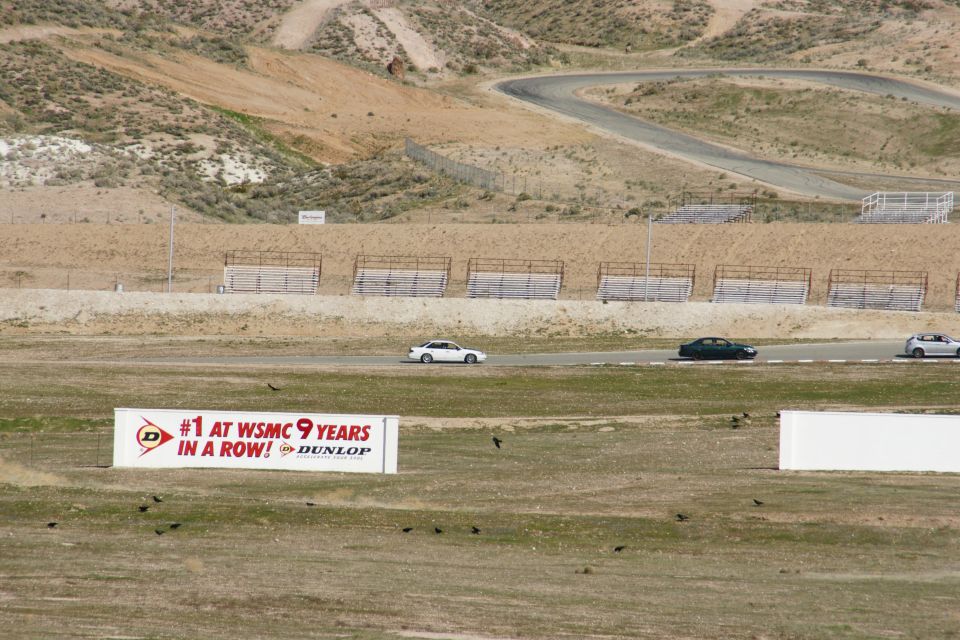 Cars on a race track with a Dunlop sign
