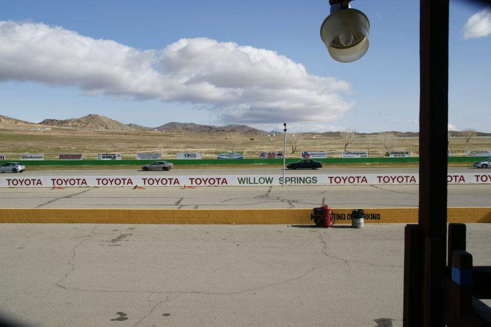 Cars on a racetrack with Toyota sponsorship and Willow Springs signage