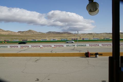 1995 Ford Taurus - A white sedan is seen on the race track at Willow Springs, with a black car also visible in the distance.
