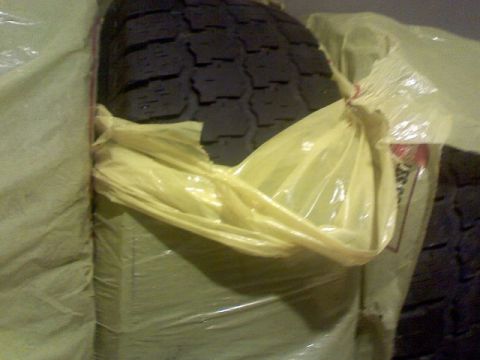 1996 Ford Bronco - A close-up view of a tire, partially covered by protective wrapping.
