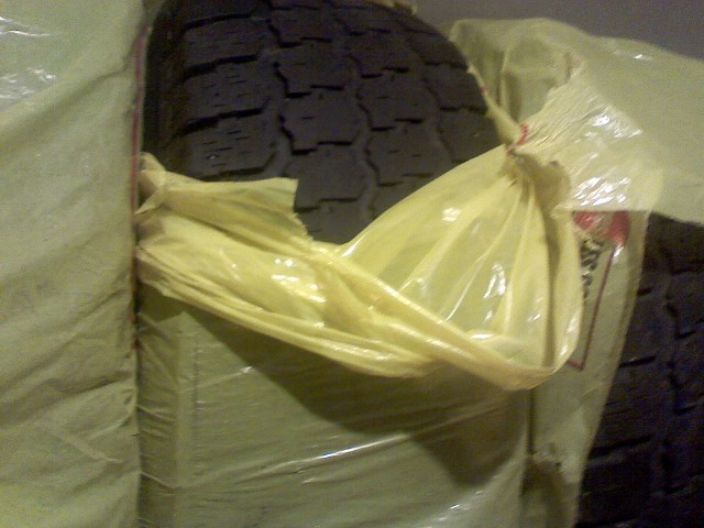 Tire wrapped in plastic and fabric