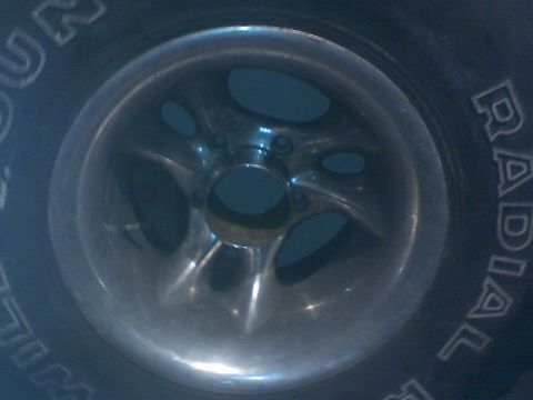 1996 Ford Bronco - A close-up view of a vehicle's wheel and tire, showing the tread pattern and rim details.