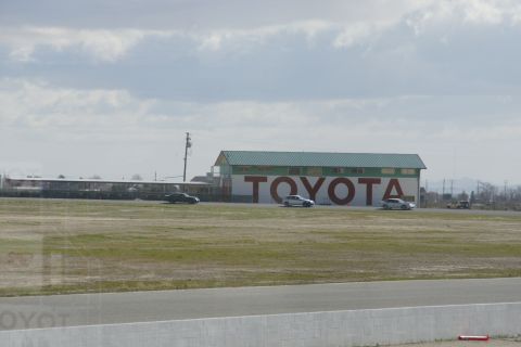 1995 Ford Taurus - Toyota dealership building with cars parked outside under a cloudy sky.
