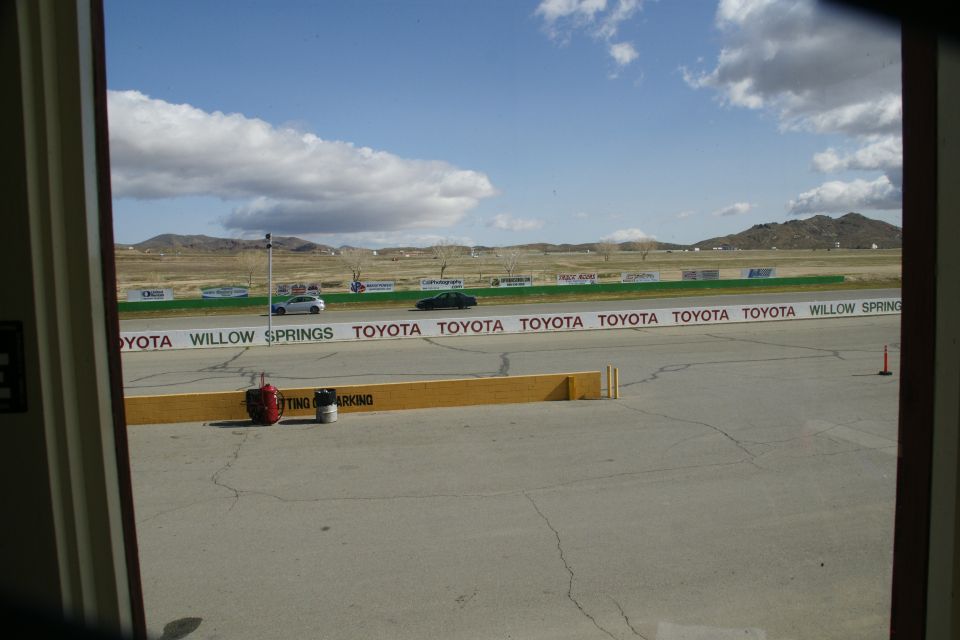 Cars on a track with Toyota Willow Springs signage
