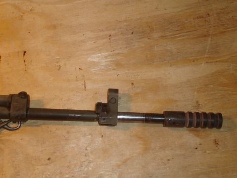 1989 Ford Bronco - Close-up of a firearm barrel with front sight assembly and a ribbed end.
